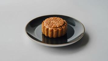 Mooncake on a plate on a white background. Chinese mid autumn festival. photo