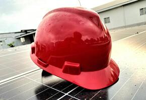 Plastic safety helmet isolated on panel surya background photo