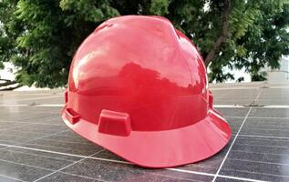 Plastic safety helmet isolated on panel surya background photo