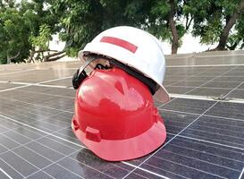 Plastic safety helmet isolated on panel surya background photo