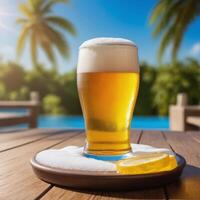 Glass of beer on the beach at sunset. Blurred background. photo