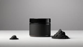 a jar of charcoal powder next to a black container photo