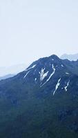 Awesome top view through clouds to high snowy mountains video