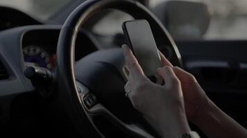 Hand using phone in car at sunset in summer, travel concept video