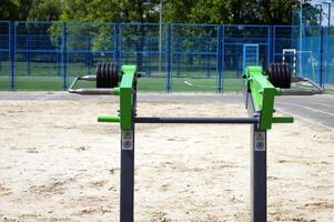Weight plates on green equipment. photo