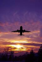 Passengers commercial airplane flying in sunset light. Concept of fast travel, holidays and business photo