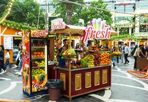 BAKU, AZERBAIJAN - MAY 20, 2020. Fruit and juices at the street farmers market. Fresh summer fruits for juice and smoothies. Summer, vitamins, healthy food concept. photo