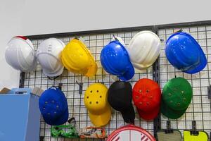 Special protective, work clothes, helmets and hard hats for builders, oil and gas industry workers are on display in the store photo