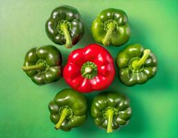 Standout Red Chili Among Stack of Green Chilies Contrast Background photo
