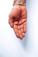 Hands of an Indian woman with red holi powder applied on hand isolated on white background. photo