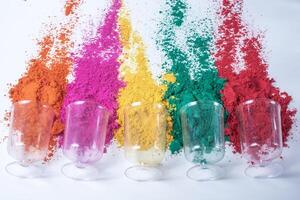 Colorful holi powder in glass isolated on white background. photo