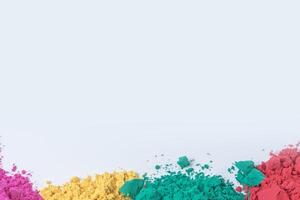 Pile of multicolored holi powder isolated on white background photo