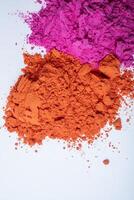 Pile of colorful holi powder on white background. photo