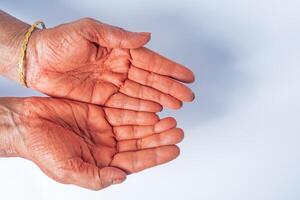 Hands of an Indian woman with red holi powder applied on hand isolated on white background. photo