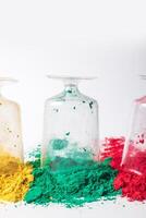 Colorful holi powder in glass jars isolated on white background. photo