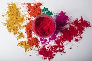 Colorful red holi powder in a glass bowl on white background and multicolored holi powder around it. photo