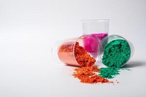 Colorful holi powder in glass bowl isolated on white background with copy space. photo