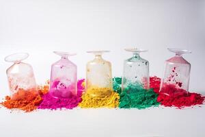 Various colorful holi powder in glass bottles isolated on white background. photo