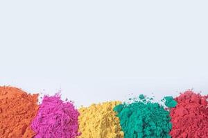 Pile of multicolored holi powder isolated on white background. photo