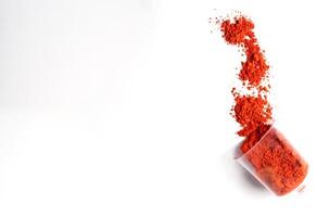 Colorful Red holi powder in a glass isolated on white background photo