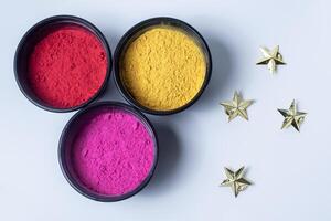 Indian Festival Holi background with colorful powder and golden star. photo