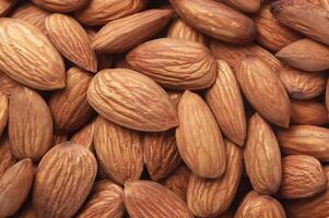 Close up of almond nuts background. Healthy food concept. photo