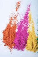 Top view of multi color holi powder isolated on white background. photo