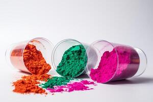 Colorful holi powder in a glass container isolated on white background. photo