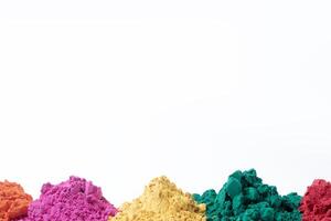 Colorful holi powder isolated on white background with copy space. photo