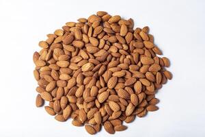 Pile of almonds on white background. Healthy food concept. photo