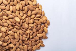 Top view of almonds on white background with copy space photo