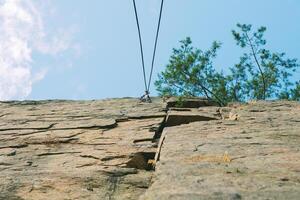 Mountain climbing wall. Training area for outdoor activities. No people. Blue sky. photo