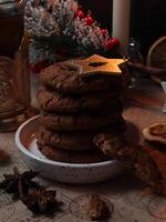 Christmas time served table with hot drink and chocolate cookies with candles and pine tree photo