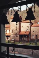 Small orthodox church bells on the church bell tower photo