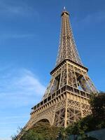 Eiffel Tower day light side view from the ground close up photo