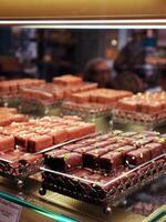 Hand made french chocolate candies laying on a cafe confectionery display photo