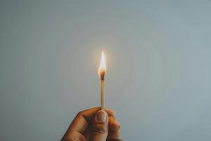 A man holds a burning match in his hand photo