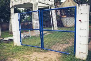 Blue Chain Link Fence Gate Locked with Key. Concept of Protecting Areas photo