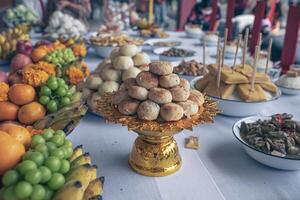 The spring rolls are in the pan with food and fruit for worshiping the deceased according to Buddhist beliefs. photo