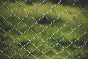 Chain link fence with blurred background . demarcation concept photo