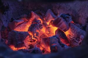 Close-up photo of hot coals in a clay oven