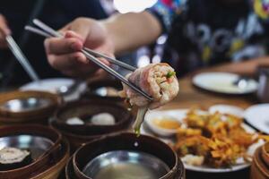 Steamed dim sum packed in bamboo containers photo