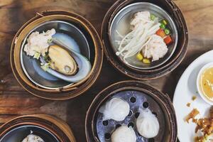 Steamed dim sum packed in bamboo containers photo