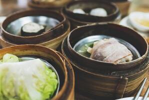 Steamed dim sum packed in bamboo containers photo