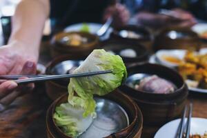 Steamed dim sum packed in bamboo containers photo