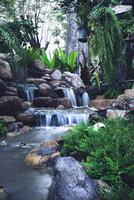 The image of water running down the rocks in the garden. photo