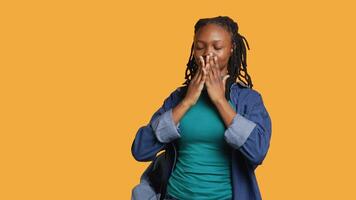 African american woman covering eyes, ears and mouth with hands, imitating the three wise monkeys. Girl doing do not see, do not hear and do not speak gesturing concept, studio background, camera A video