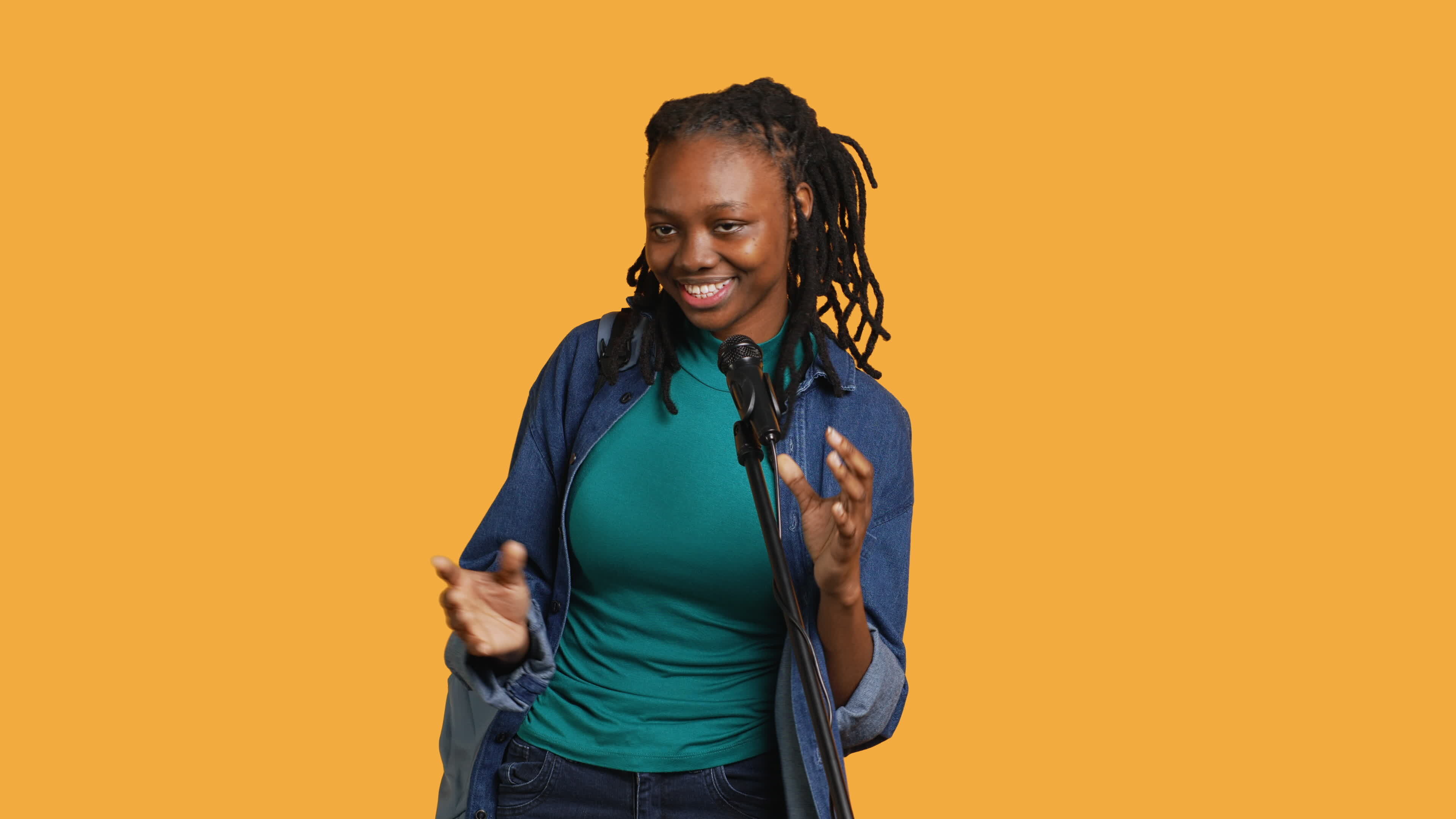 Cheerful motivational speaker talking in microphone doing stand up