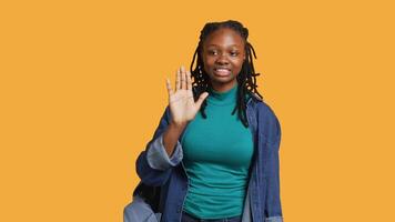 Assertive african american woman doing stop hand gesture and talking. Annoyed girl doing firm halt sign gesturing, wishing to end concept, isolated over studio background, camera A video