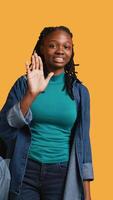 Vertical Assertive african american woman doing stop hand gesture and talking. Annoyed girl doing firm halt sign gesturing, wishing to end concept, isolated over studio background, camera B video